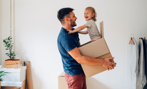 Dad holding child in moving box