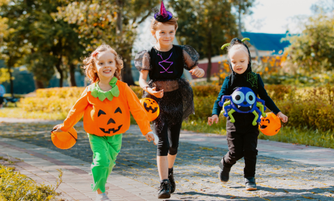 Three kids in Halloween costumes