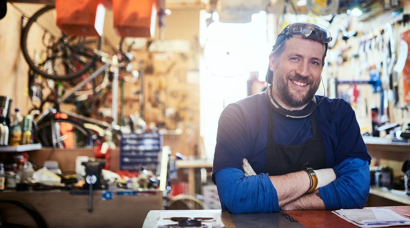 Bike shop owner smiling at front counter