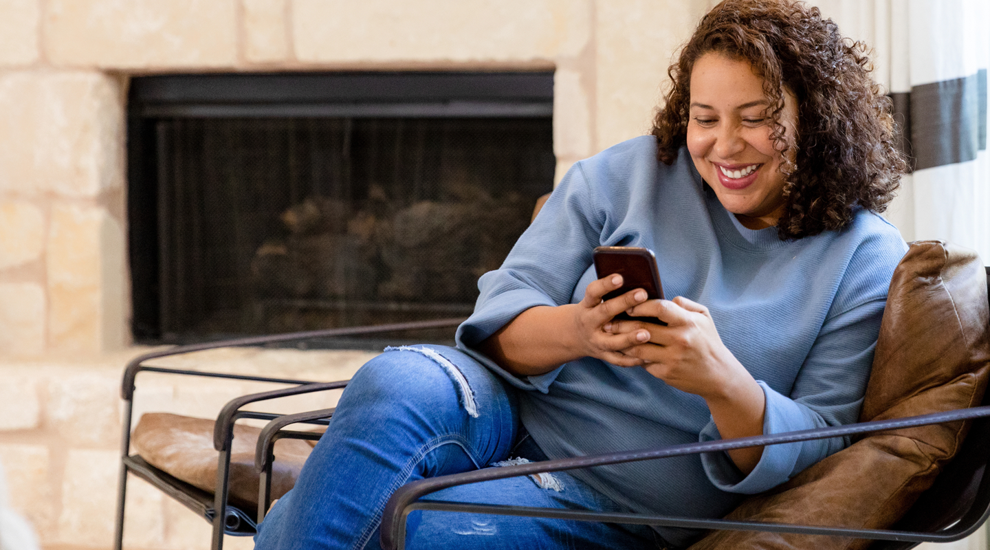 Woman at home learning on her phone