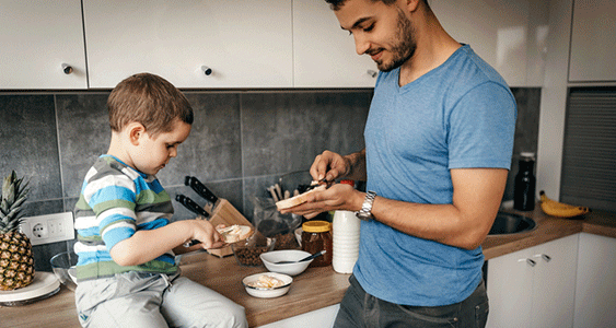 DadAndSonMakingSandwichesInKitchen